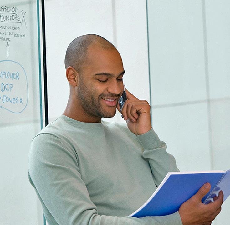 Consultor de CORE OPS revisando notas operativas por teléfono